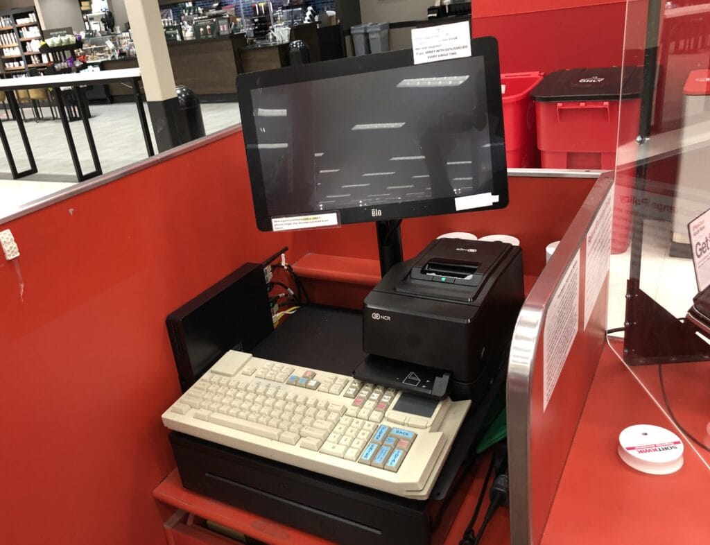Checkout counter with an Elo touchscreen, NCR receipt printer and point of sale keyboard