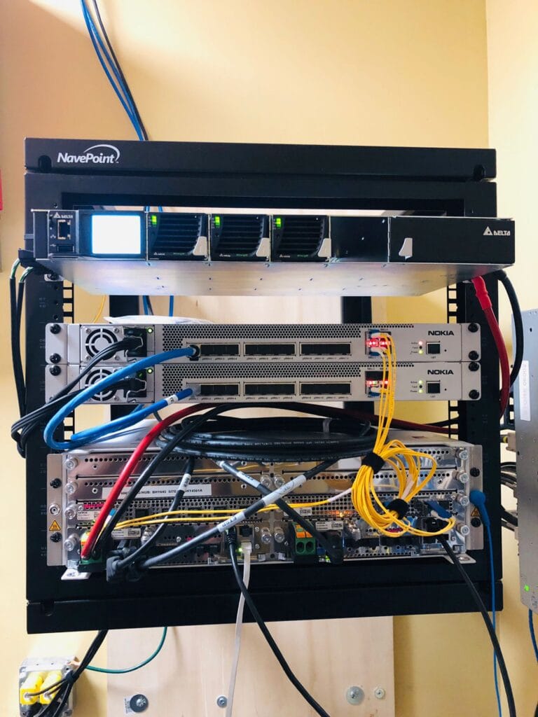 Wall-mounted NavePoint rack with cooling fans and two Nokia radio units